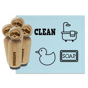 May include: Wooden stamps with sloth faces and the text "SNIGGLESLOTH" are next to a light blue background with the word "CLEAN", a bathtub, a rubber duck, and a soap sign.