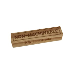 May include: A wooden stamp with the text "NON-MACHINABLE" and the logo "SNIGGLESLOTH" in a brown font.