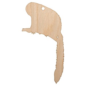 May include: A wooden beaver-shaped cutout with a hole at the top for hanging. The beaver is depicted in profile, with a detailed tail and a small triangle cut out near the tail. The wood has a natural, light brown color.