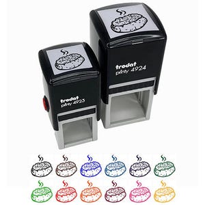 May include: Two black self-inking stamps with a white image of a cooked food item on top. The stamps are labeled "trodat printy 4923" and "trodat printy 4924". Below are several colored versions of the food item.