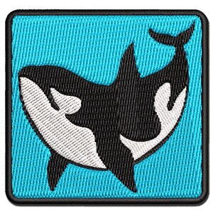 May include: A square embroidered patch featuring a black and white orca whale design centered on a bright cyan blue background. The patch has a thick black stitched border and a textured fabric appearance with visible thread details throughout.