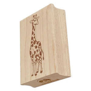 May include: A wooden stamp featuring a giraffe design. The giraffe has a long neck, brown spots, and is standing upright. The stamp is made of light-colored wood and has a curved handle for easy use. The stamp is angled slightly, showing the side and bottom.