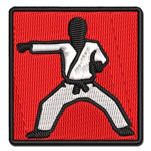 May include: A square embroidered patch featuring a red background with a black border. The central design depicts a figure in a white martial arts uniform with a black belt, shown in a dynamic punching stance with black hands and feet.
