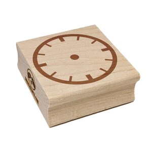 May include: A wooden stamp with a brown clock face design. The clock face has a circular outline with markings for the hours. The stamp is made of light-colored wood and has the text "www.etsy.com" on the side.