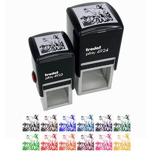 May include: Two black Trodat self-inking stamps, one larger than the other, with a mountain goat design. The stamps have the text "trodat printy 4923" and "trodat printy 4924". Below are several color options for the stamp design.