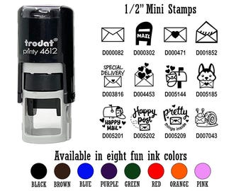 May include: A black and gray self-inking stamp with the text "trodat printy 4612" on the side. The stamp is surrounded by a grid of 10 different 1/2 inch mini stamps with various designs, including mailboxes, envelopes, hearts, and a snail. The text "Available in eight fun ink colors" is below the grid, with eight colored circles representing the ink colors: black, brown, blue, purple, green, red, orange, and pink.