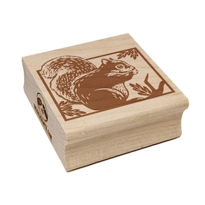 May include: A wooden stamp featuring a detailed brown illustration of a squirrel within a rectangular frame. The squirrel is depicted in profile, holding something in its mouth. The stamp has rounded edges and the text "www.etsy.com" is visible on the side.