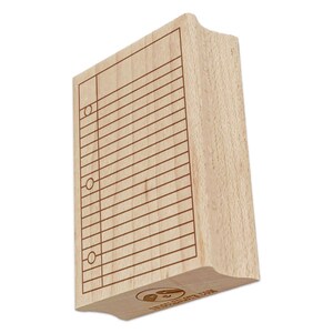 May include: A rectangular wooden stamp with a library card design. The stamp features a grid of horizontal lines and circles, with the text "UNCOMMONLOTTE.COM" at the bottom. The stamp is made of light-colored wood.