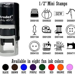 May include: A black and gray Trodat Printy 4612 stamp with various sewing-themed icons, including a thimble, needle, and sewing machine. The image also displays eight ink color options: black, brown, blue, purple, green, red, orange, and pink.