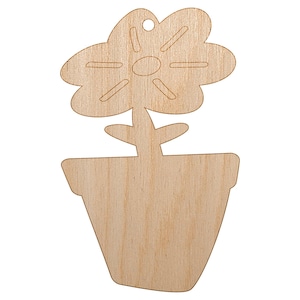 May include: A wooden flower in a pot cutout. The flower has a detailed petal design and a hole at the top for hanging. The pot is a simple, trapezoid shape. The wood has a natural, light brown color.
