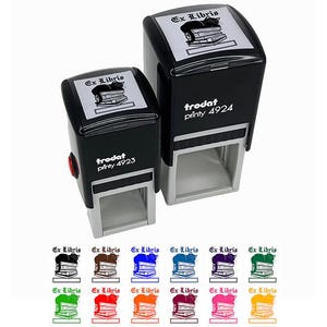 May include: Two black Ex Libris stamps of different sizes. Each stamp has a rectangular design with the text "Ex Libris" above a graphic of a cat on books. The stamps are labeled "trodat printy 4923" and "trodat printy 4924". Below are color variations.
