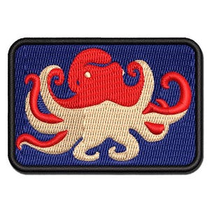 May include: A rectangular embroidered patch featuring a stylized octopus design. The octopus has a red upper body and beige lower tentacles, set against a dark blue background. The entire patch is bordered by a thick black stitched edge.