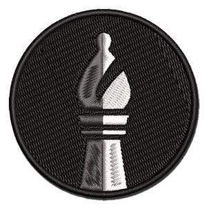 May include: A circular embroidered patch featuring a split-tone design of a chess bishop piece. The left side of the bishop is rendered in dark gray and black thread, while the right side is in white and light gray, set against a black background.