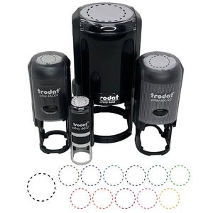 May include: A collection of black self-inking stamps of various sizes, with the brand name "Trodat" visible. The stamps are arranged on a white background, with examples of dotted circle imprints in various colors below.