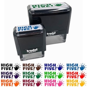 May include: Two black self-inking stamps with the text "HIGH FIVE!" and a green handprint on the top stamp and a blue handprint on the bottom stamp. The stamps are from the Trodat brand.