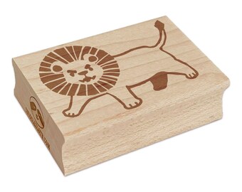 May include: A wooden stamp featuring a cartoon lion design. The lion is brown and has a detailed mane and a smiling face. The stamp is rectangular with rounded edges and the text "WHISCOLOTA.COM" is visible on the side.