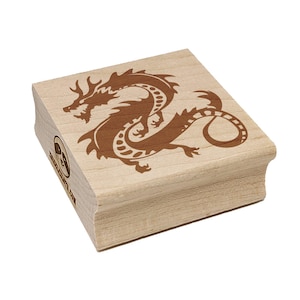 May include: A wooden stamp featuring a detailed brown dragon design. The dragon is depicted in a stylized, flowing pose. The stamp has a rectangular shape with rounded edges. The text "www.etsy.com" is visible on the side.