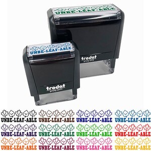 May include: Two black self-inking stamps with the text "UNBE-LEAF-ABLE" in blue and green. The stamps are labeled "trodat printy 4911". Below the stamps are multiple rows of the phrase "UNBE-LEAF-ABLE" in various colors.