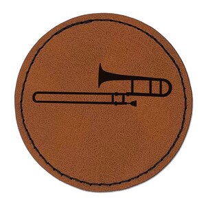 May include: A brown leather coaster with a black silhouette of a trombone.