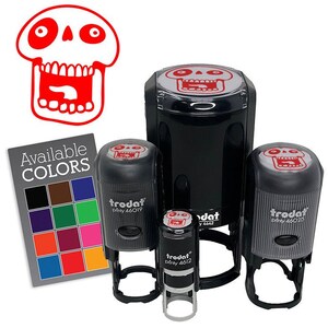 May include: A collection of black and gray self-inking stamps with a red skull design. The stamps are in various sizes, with the largest one in the center. A color chart with the text "Available COLORS" is also included.