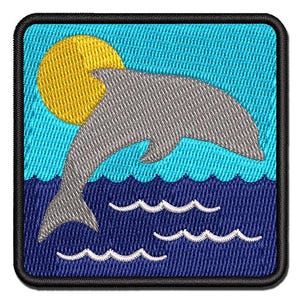 May include: A square embroidered patch featuring a grey dolphin leaping out of dark blue water against a light blue sky. A bright yellow sun is positioned behind the dolphin. The entire design is framed by a thick black stitched border.