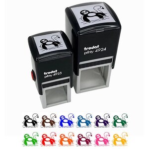 May include: Two black Trodat self-inking stamps with a sloth and swan design. The stamps have a black ink pad and a white background. The text "trodat printy 4923" and "trodat printy 4924" are printed on the stamps. Below are several colored sloth and swan designs.