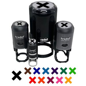 May include: A collection of black self-inking stamps with an 'X' design, in various sizes. The stamps are labeled 'trodat' and 'printy'. Below are examples of the 'X' in different colors, including brown, blue, and green.