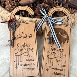 May include: Two wooden Christmas door hangers with a key and a black and white checkered ribbon. The hangers are engraved with the text "Santa's magic key for our home without a chimney".