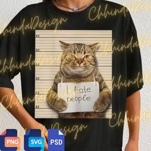 May include: Black t-shirt featuring a tabby cat posing for a mugshot. The cat holds a sign that reads "I hate people." The background includes a height chart. The shirt has the words "Chhinda Design" in a cursive font.