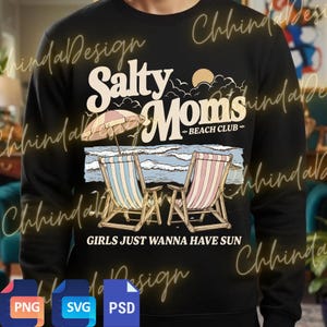 May include: Black sweatshirt with a beach-themed graphic. The design features the text "Salty Moms Beach Club" with an illustration of beach chairs, an umbrella, and ocean waves. The phrase "GIRLS JUST WANNA HAVE SUN" is also included.