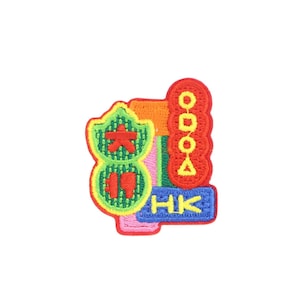 May include: A colorful embroidered patch with the letters "HK" in blue, "81" in green, and "ODOO" in red. The patch has a star and other geometric shapes.