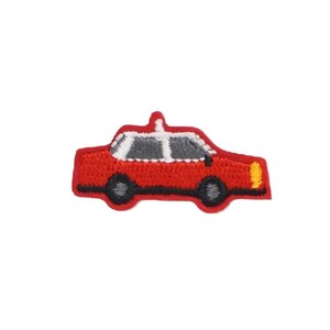 May include: Red embroidered iron-on patch of a taxi cab.