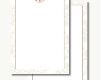 May include: Two sheets of stationery with a white background and a gold floral border. A small pumpkin illustration is at the top of the first sheet. The pumpkin is white with brown accents. The stationery is blank.