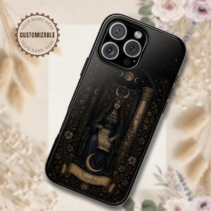 May include: A black smartphone case featuring a dark, intricate illustration of a robed figure holding a scroll, adorned with crescent moons, stars, and floral patterns. A banner at the bottom displays the name Sandra in cursive script.