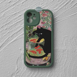 May include: A green phone case featuring a whimsical illustration of a black cat reaching into a bowl of goldfish. The artwork has a vintage, painterly style with floral and botanical elements in the background.