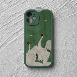 May include: Green phone case with a white crane design. The case has a cutout for the camera lens and a raised lip around the edges to protect the screen.