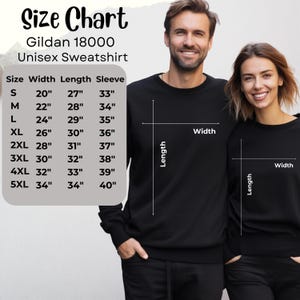 May include: A size chart for a Gildan 18000 unisex sweatshirt, with measurements in inches for sizes S through 5XL. The chart includes width, length, and sleeve measurements. A man and woman are wearing black sweatshirts.
