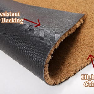 May include: Close-up of a doormat with a brown coir fiber surface and a black slip-resistant rubber backing. Text on the image reads "Slip Resistant Rubber Backing" and "High Quality Coir Fibers".