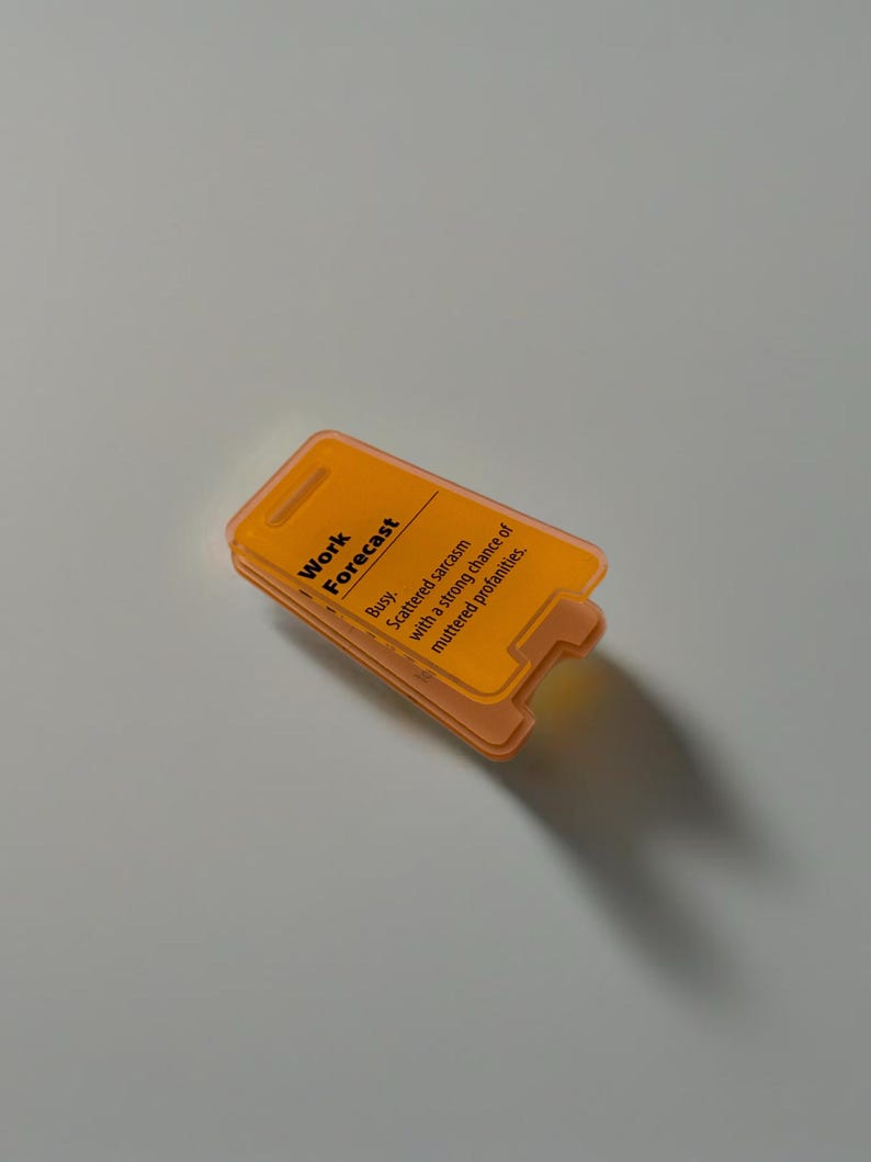 May include: Orange plastic sign with the text "Work Forecast" and "Busy. Scattered sarcasm with a strong chance of muttered profanity."