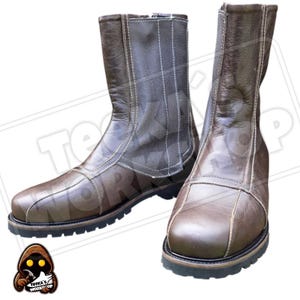 May include: A pair of brown leather boots with a zip closure and white stitching. The boots have a rounded toe and a thick, black sole. The boots are approximately 25 cm tall.