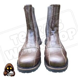 May include: A pair of brown leather boots with a zip fastening. The boots have a square toe design and a thick, black sole. The stitching is a lighter brown colour, and the boots appear to be new. The text "Teeka's Workshop" is visible in the background.