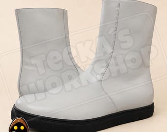 May include: A pair of mid-calf boots in a light gray color with a smooth finish and a thick black rubber sole. The boots feature a vertical seam running up the side and a watermark text overlay that reads TEEKA'S WORKSHOP across the center.