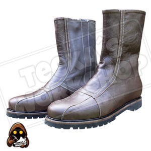 May include: A pair of brown leather boots with a zip closure and white stitching. The boots have a round toe and a black sole. The boots are approximately mid-calf height.