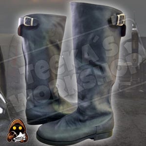 May include: A pair of black leather knee-high boots with buckles. The boots have a slightly distressed look and are made of a soft, supple leather.