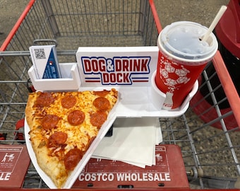 May include: A white plastic tray designed for a shopping cart, featuring a slot for a business card, a cup holder with a red Coca-Cola cup, and a flat surface holding a slice of pepperoni pizza. The tray displays the text DOG & DRINK DOCK.