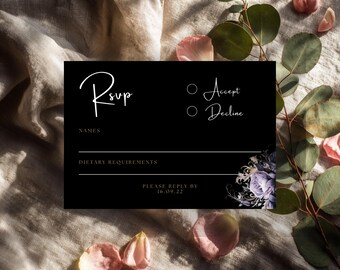 May include: Black RSVP card with white script text and floral design. The card includes fields for names and dietary requirements, with options to accept or decline. The bottom of the card reads "Please reply by 16.09.22".
