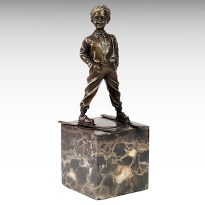 May include: Bronze sculpture of a young boy standing on a marble base. The boy is wearing a shirt and pants and is holding his hands in his pockets. The sculpture is on a marble base.