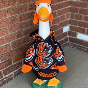 Team fleece hooded sweatshirt for large concrete porch goose! Includes attached wings and matching trapper hat! Can be made for any team!
