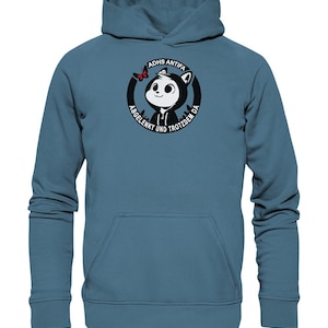 May include: A blue hoodie featuring a black and white graphic of a cartoon character with a butterfly. The graphic reads "ADHS Antifa Abgelenkt und Trotzdem Da".