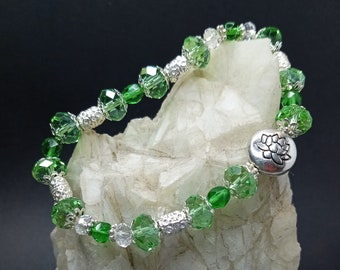 Green and clear crystal stretch bracelet with silver lotus and accent beads